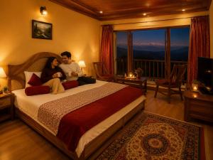 a man and woman sitting on a bed in a hotel room at Swaasha Vista in Kausani +12 photos