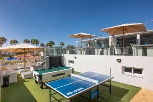 a ping pong table on the roof of a house at Ona Sueño Azul in Callao Salvaje