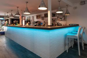 a blue bar in a restaurant with two chairs at Ona Sueño Azul in Callao Salvaje
