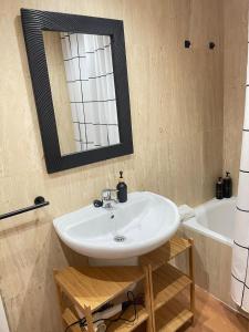 a bathroom with a sink and a mirror and a tub at Apartamento El Gorgol in Tramacastilla de Tena +13 photos