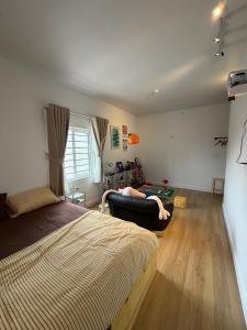 a bedroom with a bed and a person laying on a couch at 12 Homestay & Hotel in Lạng Sơn +19 photos
