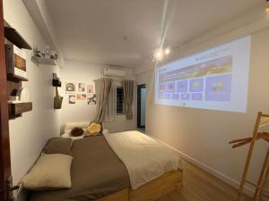 a bedroom with a large projection screen on the wall at 12 Homestay & Hotel in Lạng Sơn