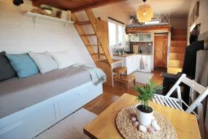 a bedroom with a bed and a table in a room at Tiny house U Dlouháče in Litoměřice