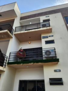 a white building with a balcony with a red object on it at De Atrium apartment in Galadima