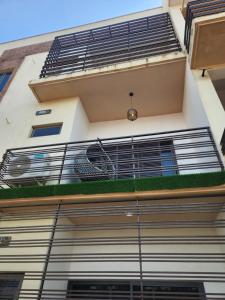 a building with a balcony with a fan at De Atrium apartment in Galadima