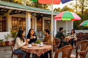 a group of people sitting at tables at a restaurant at Swaasha Vista in Kausani