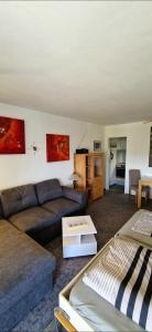 a living room with a couch and a table at Ferienwohnung Ronja im Hause Bergland Altreichenau in Neureichenau