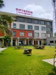 a building with tables and benches in a park at Mayur baag resort in Sāgar +5 photos
