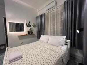 a bedroom with a bed with white sheets and pillows at Cazabela in Casisang +16 photos