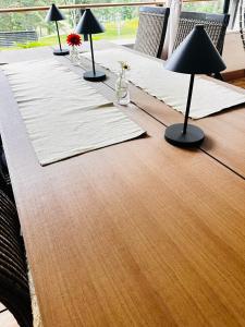 a wooden table with four lamps on top of it at Villa Ekbladh in Västanfjärd