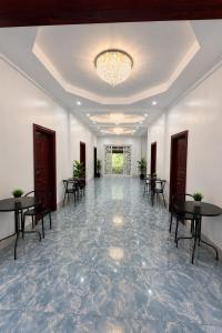 a large room with tables and chairs and a chandelier at Cazabela in Casisang