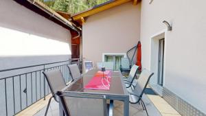 a table and chairs on the balcony of a building at FERIENWOHNUNGEN TANJA - dein Wohlfühlhaus in Kappl in Kappl