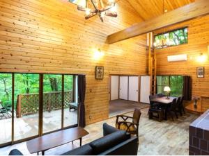 a living room with wooden walls and a ceiling at rinne 2nd living Sauna Villa Nasu in Nasu
