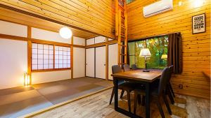 a dining room with a table and chairs at rinne 2nd living Sauna Villa Nasu in Nasu