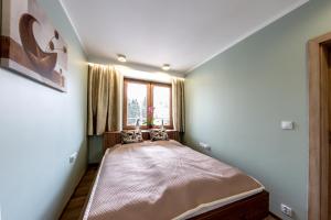 Ένα ή περισσότερα κρεβάτια σε δωμάτιο στο Apartament Eva