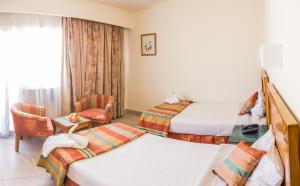 Postel nebo postele na pokoji v ubytování Hapi Hotel