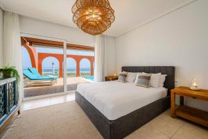 a bedroom with a bed and a view of the ocean at Villa Afreen Playa in Morro del Jable +39 photos