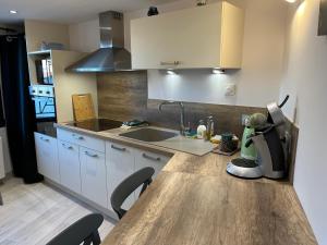 a kitchen with a wooden counter top with a mixer at "Le 3 Bis" Climatisé,1 lit King Size in Venoy +19 photos