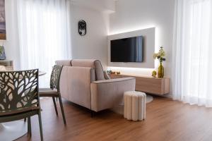 a living room with a couch and a tv at DELL'EDERA Luxury Home in Polignano a Mare