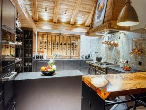 a large kitchen with a counter with a bowl of fruit on it at Arlberg View Residence in St. Moritz +10 photos