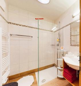 a bathroom with a shower and a sink at Landhaus Wildschwendt in Ellmau +41 photos
