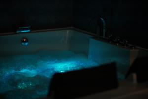 a bathroom with a bath tub with a sink at Zen Lux in Zaječar +14 photos