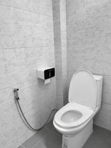 a bathroom with a toilet with a hose connected to it at Samanta By The Hill in Ko Larn +17 photos
