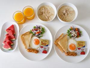 four plates of breakfast food with eggs and toast at Samanta By The Hill in Ko Larn