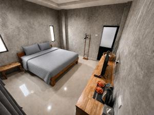 a bedroom with a bed and a wooden table at Samanta By The Hill in Ko Larn