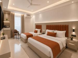 a hotel room with two beds and a desk at Hotel Cloud Suites Delhi Airport in New Delhi