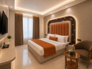 a hotel room with a bed and a chair at Hotel Cloud Suites Delhi Airport in New Delhi
