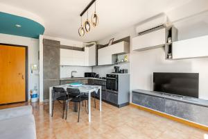 a kitchen with a table and chairs in a room at Soffio di Luce in Calderara di Reno