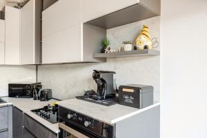 a kitchen with a counter top with a coffee maker at Soffio di Luce in Calderara di Reno +18 photos
