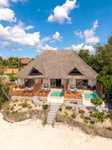 a house on the beach with a swimming pool at Pongwe Beach Hotel in Pongwe