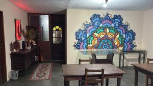 a room with a colorful mural on the wall at Pousada Quintal da Cachoeira in São Thomé das Letras