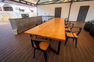 a large wooden table and chairs in a room at Spacious 5BR Canopy Home with Farm in Kepala Batas