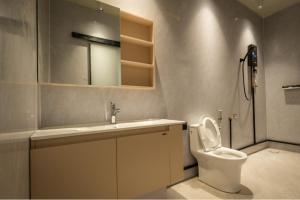 a bathroom with a toilet and a sink and a mirror at Spacious 5BR Canopy Home with Farm in Kepala Batas +23 photos