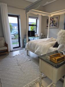 a bedroom with a bed and a table and a window at 8 Guildford in George