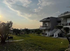 a view of a building with a green yard at BELA Apartments Kariani Near Ofrinio in Karianí