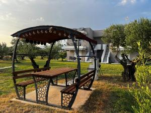 a picnic table in a park next to a building at BELA Apartments Kariani Near Ofrinio in Karianí +3 photos