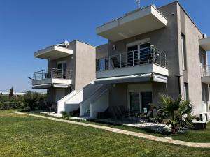 a large building with chairs and a balcony at BELA Apartments Kariani Near Ofrinio in Karianí