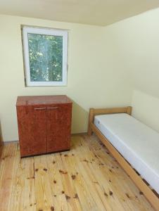 a small room with a bed and a window at Sumski raj Gornje podunavlje in Sombor