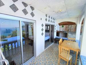 a room with a table and a balcony at Magic View Apartments Koh Tao in Ko Tao