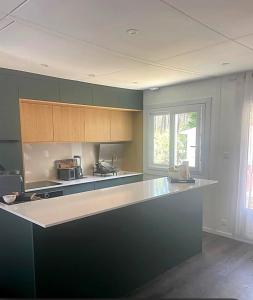a kitchen with a large island in the middle at Maison huit places Piscine tennis Lacanau plage in Lacanau