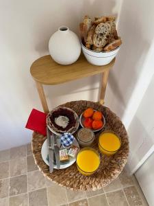 a table with a plate of food and a bowl of bread at Mas du Rocan in Aubignan