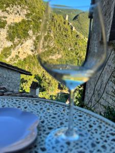 a glass of white wine sitting on a table at Borgosulnera - Oltre il tempo in Ferentillo +4 photos