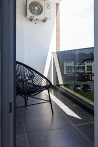 a bench sitting on the balcony of a building at Apartmani Savić expres Laktasi in Laktaši
