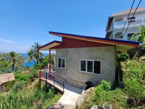 a house on a hill with a staircase leading to it at Magic View Apartments Koh Tao in Ko Tao