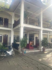 a scooter parked in front of a building at Dokban Hotel in Luang Prabang
