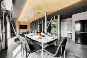 a dining room with a white table and chairs at The Lavenridge in Nakafurano